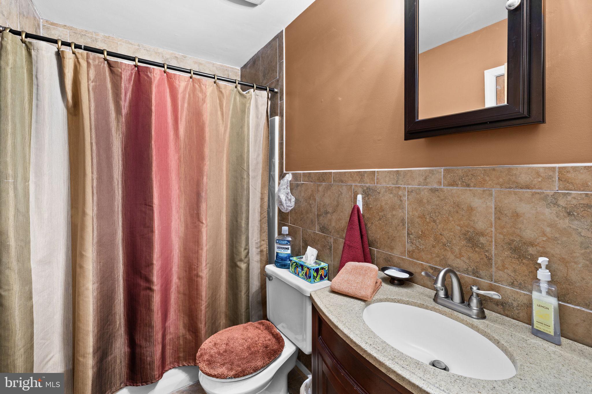 227 Cedar Ridge Drive Ruther Glen, VA 22546 - Photo 18 of 44 a bathroom with a sink vanity mirror and toilet