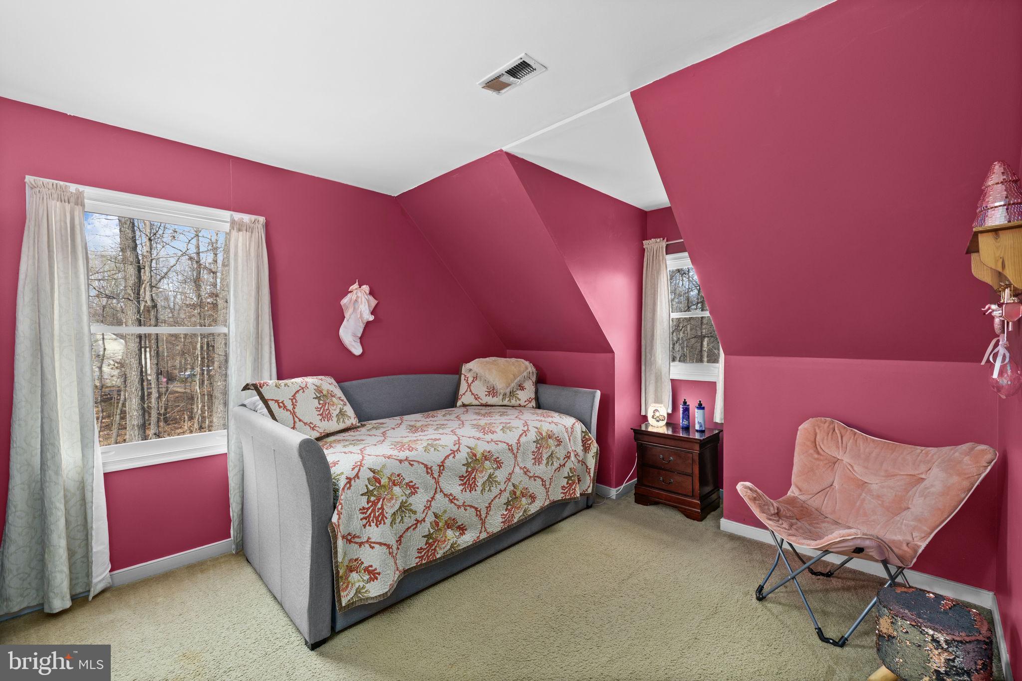 227 Cedar Ridge Drive Ruther Glen, VA 22546 - Photo 19 of 44 a bedroom with a bed and wooden floor