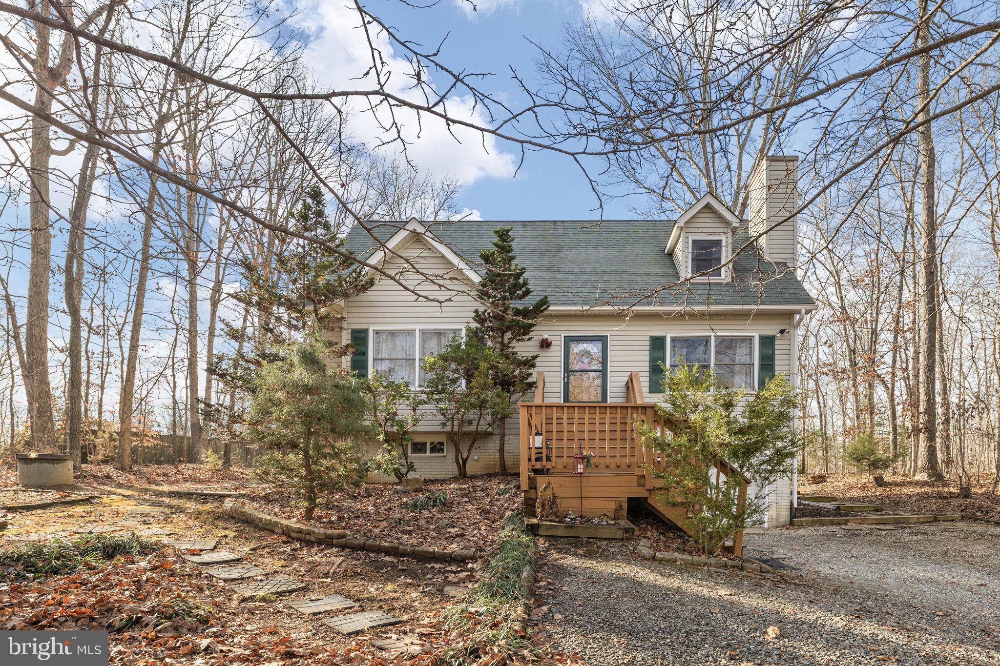 227 Cedar Ridge Drive Ruther Glen, VA 22546 - Photo 2 of 44 a front view of a house with garden