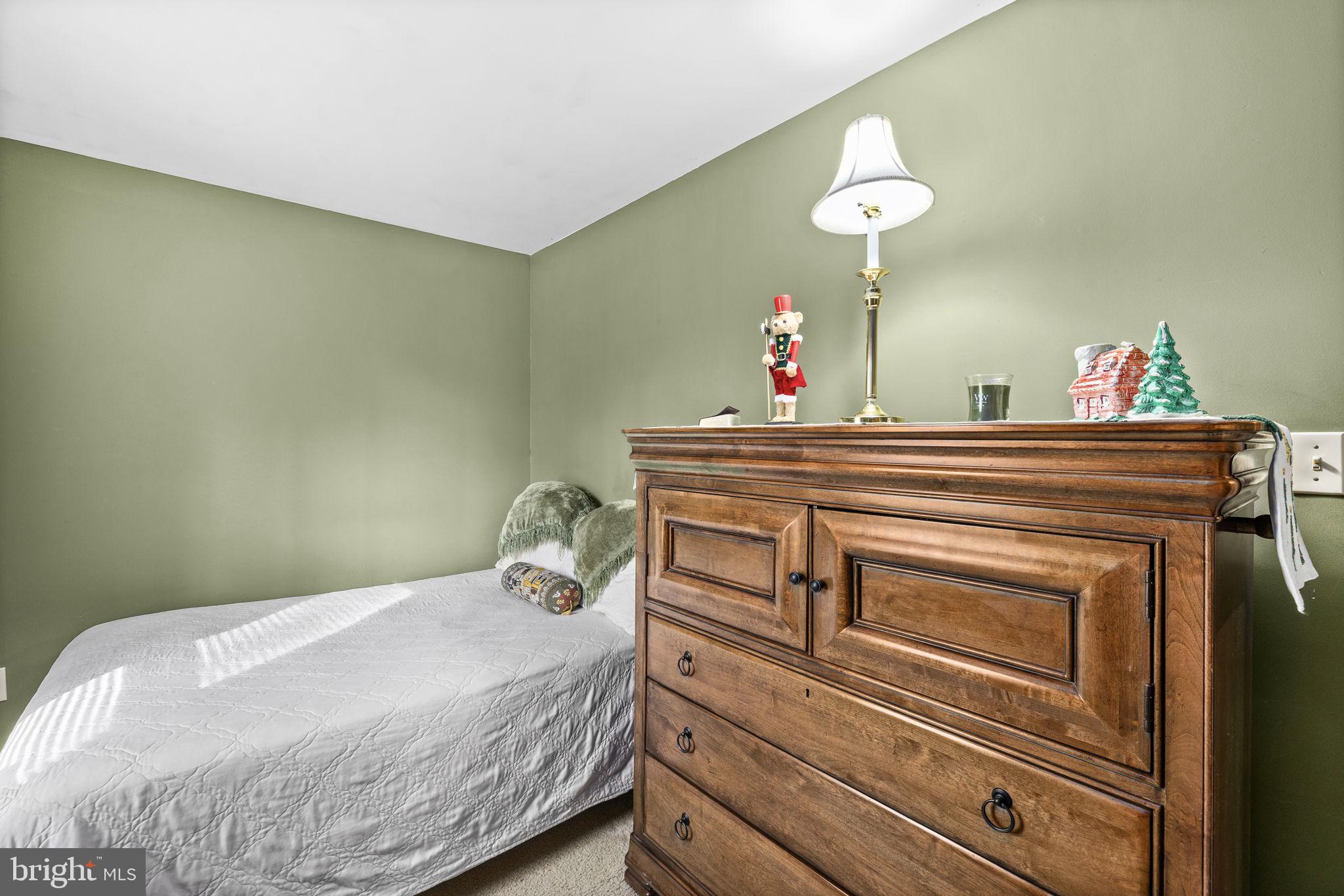 227 Cedar Ridge Drive Ruther Glen, VA 22546 - Photo 21 of 44 a bedroom with a bed and a chandelier