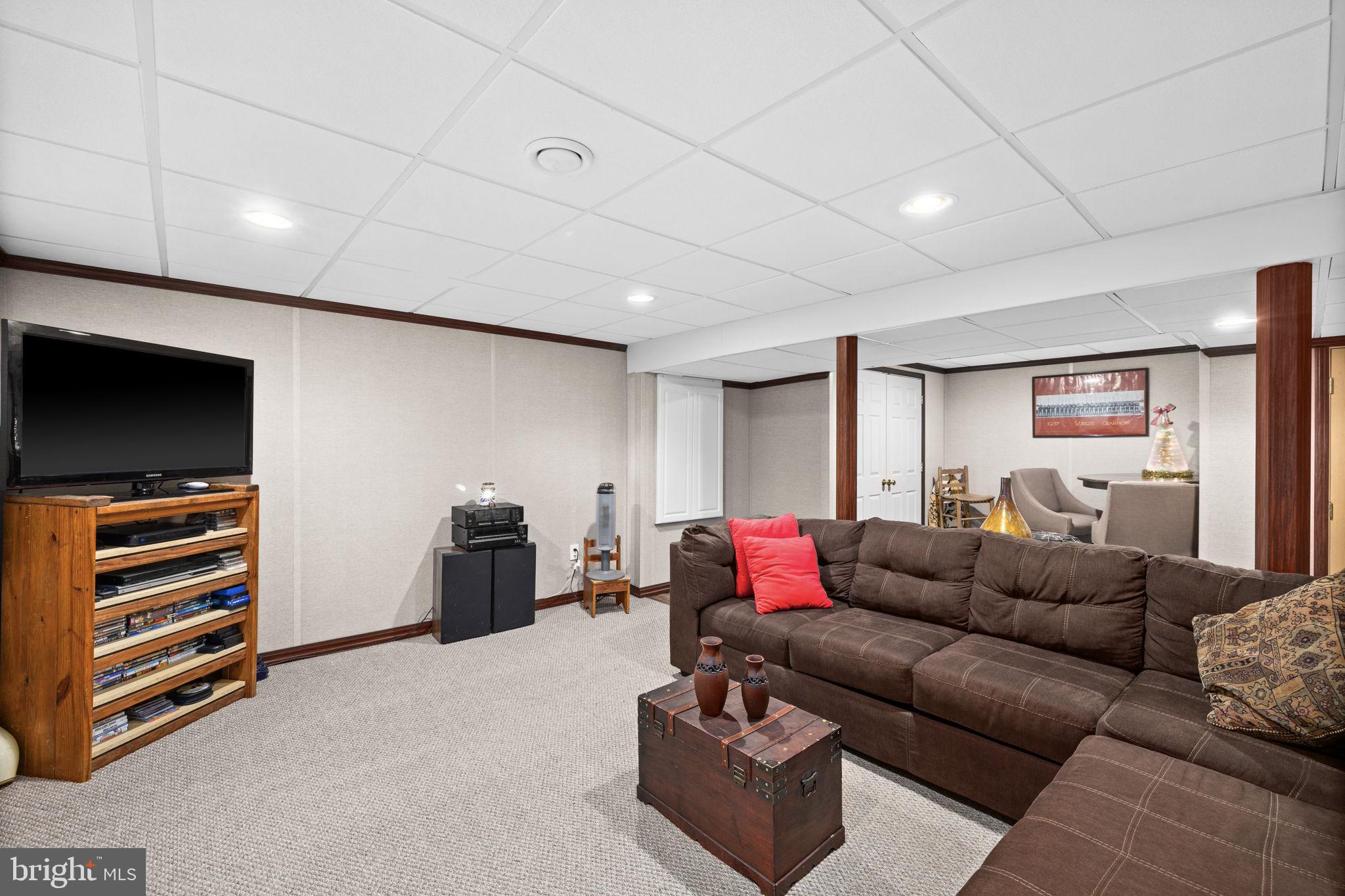227 Cedar Ridge Drive Ruther Glen, VA 22546 - Photo 22 of 44 a living room with furniture and a flat screen tv