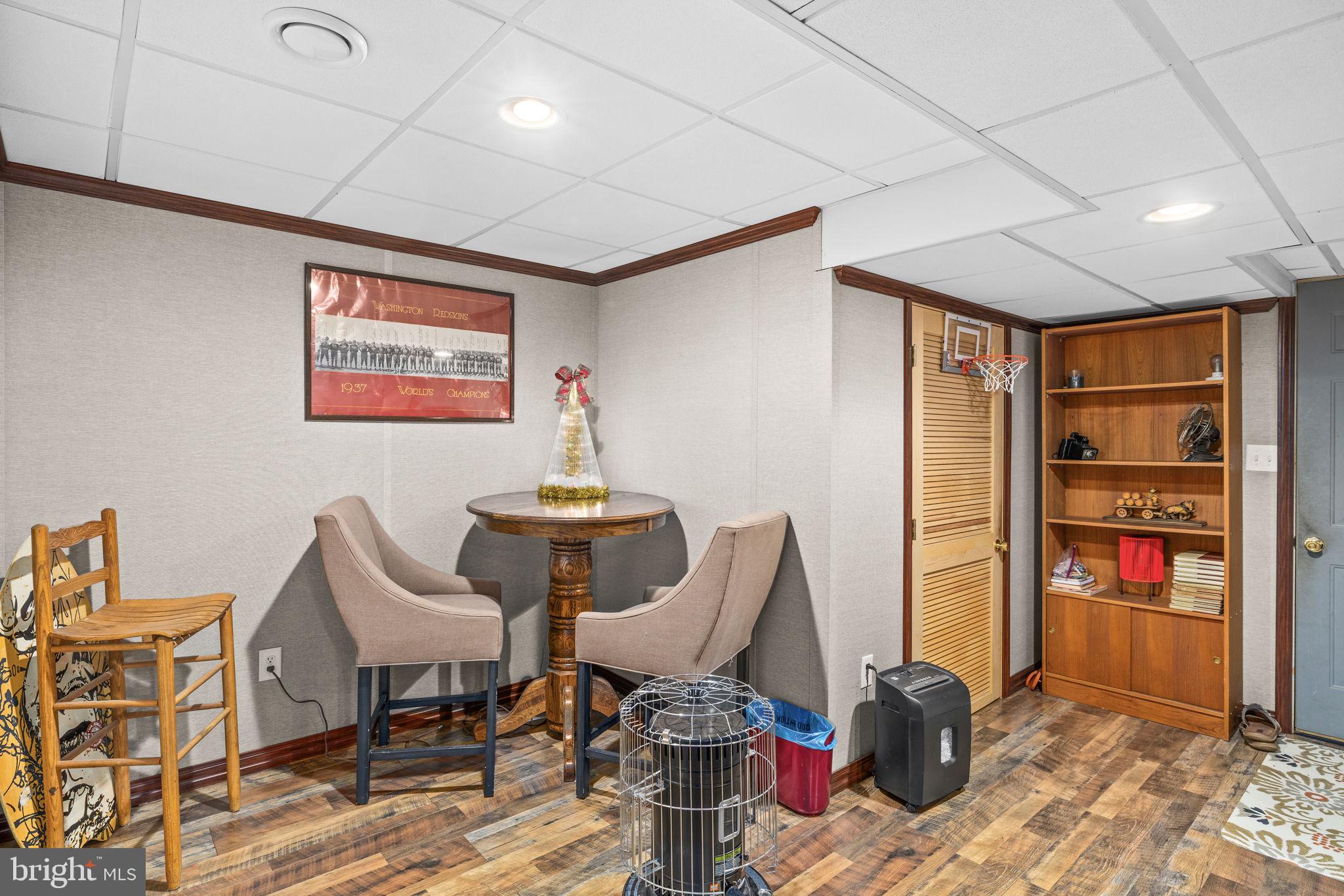 227 Cedar Ridge Drive Ruther Glen, VA 22546 - Photo 25 of 44 a living room with furniture a rug and a bookshelf