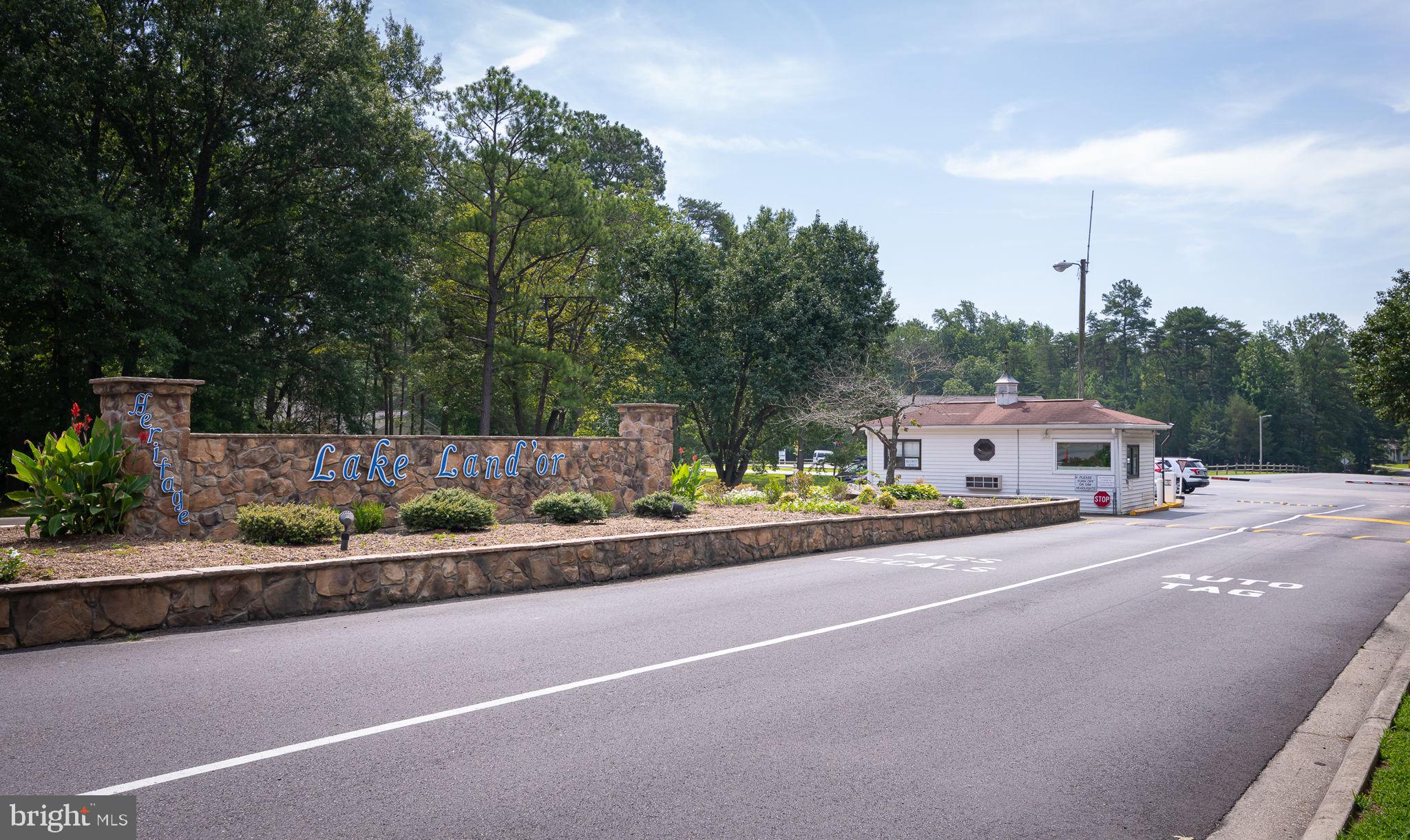 227 Cedar Ridge Drive Ruther Glen, VA 22546 - Photo 44 of 44 a front view of a house with a garden and street view