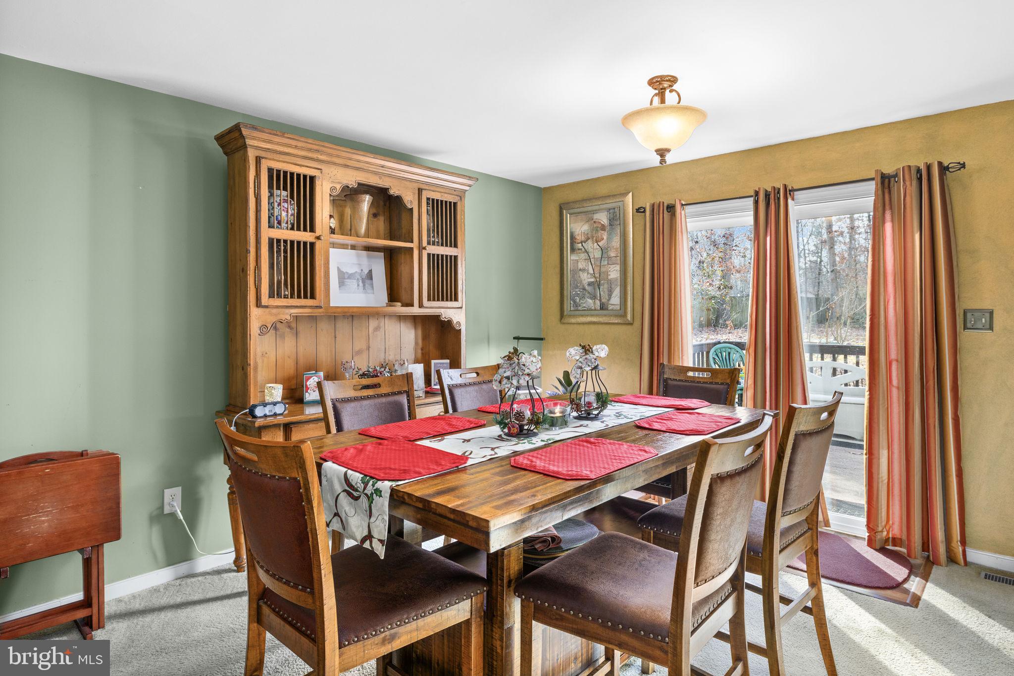 227 Cedar Ridge Drive Ruther Glen, VA 22546 - Photo 9 of 44 a view of a dining room with furniture window and outside view