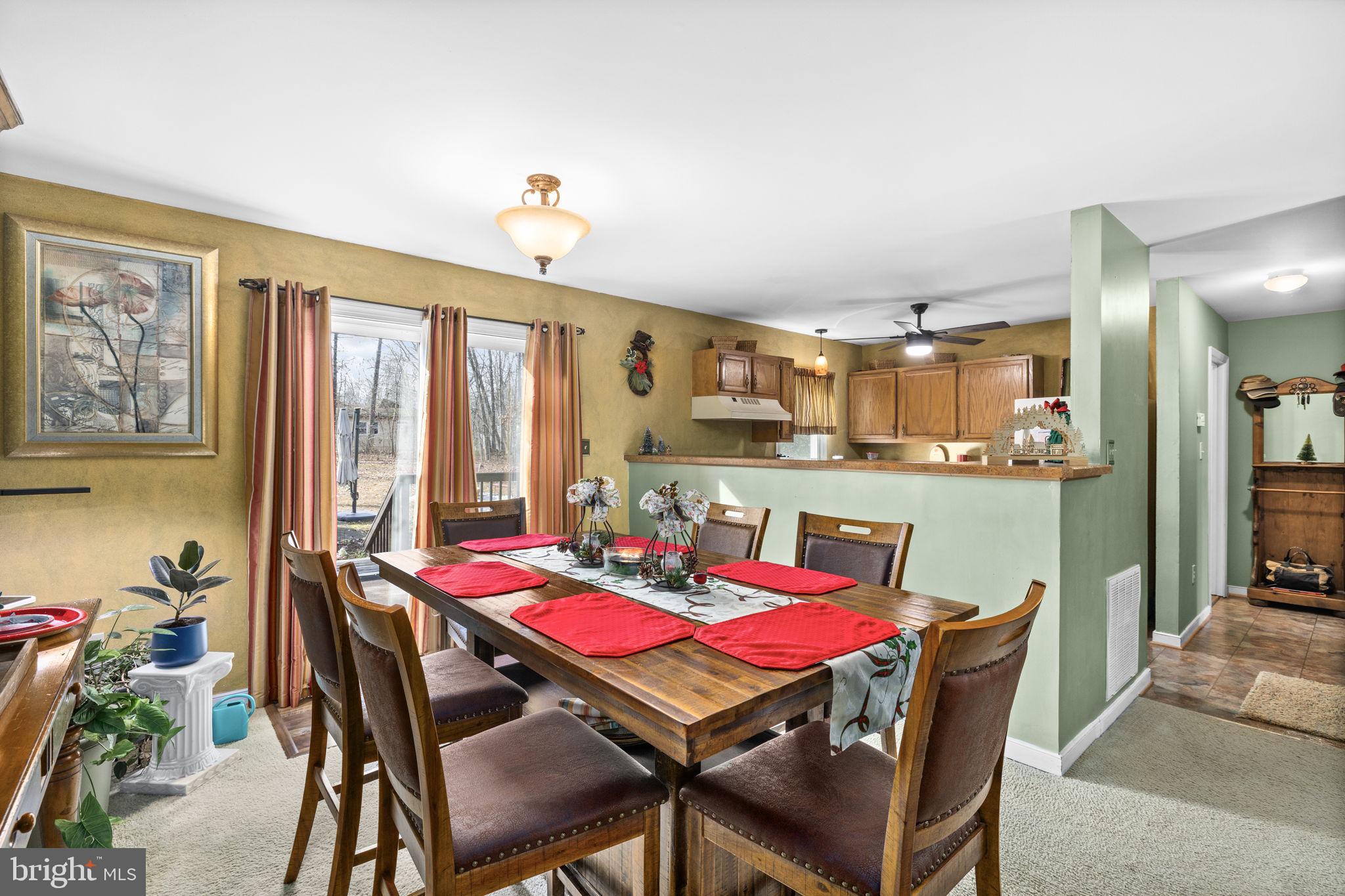 227 Cedar Ridge Drive Ruther Glen, VA 22546 - Photo 10 of 44 a view of a dining room with furniture window and outside view