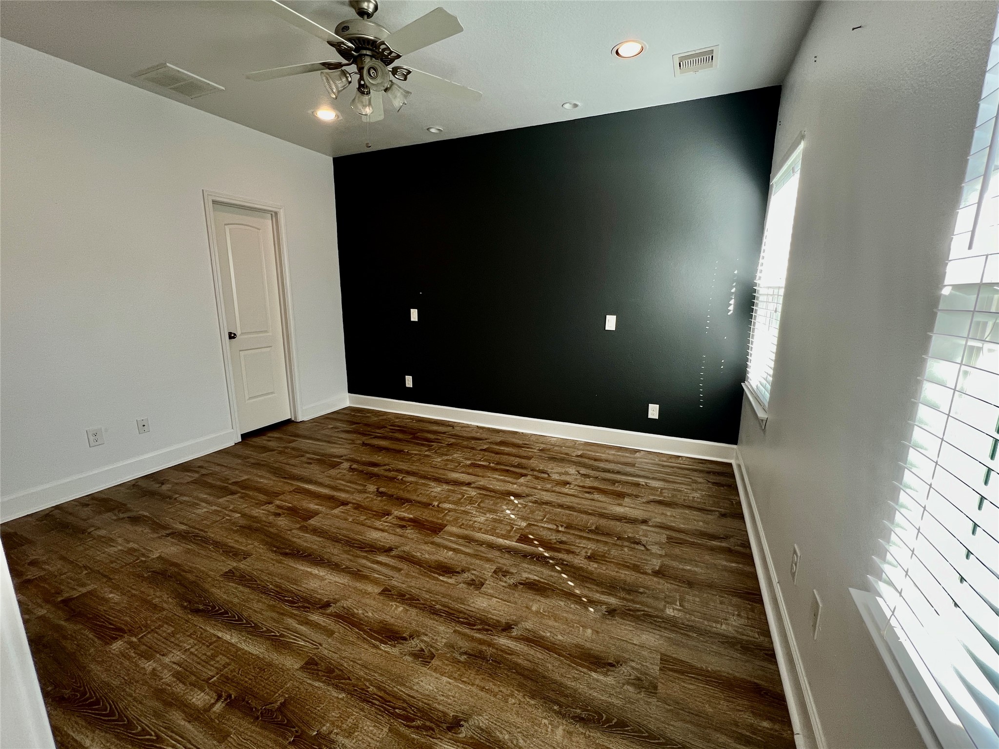 312 Mission Lane Houston, TX 77011 - Photo 18 of 19 a view of a livingroom with a ceiling fan and window