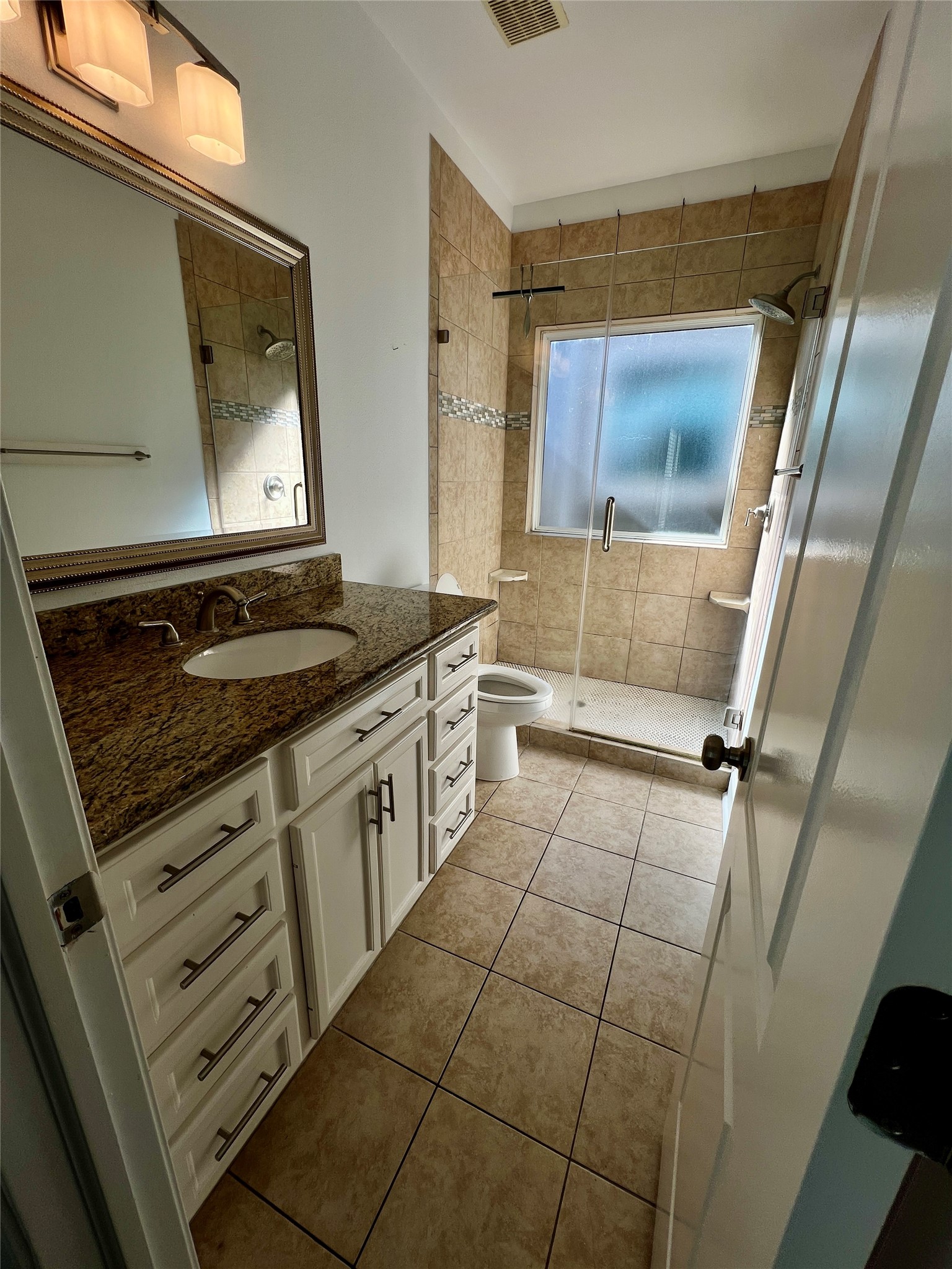 312 Mission Lane Houston, TX 77011 - Photo 19 of 19 a bathroom with a sink a vanity and mirror