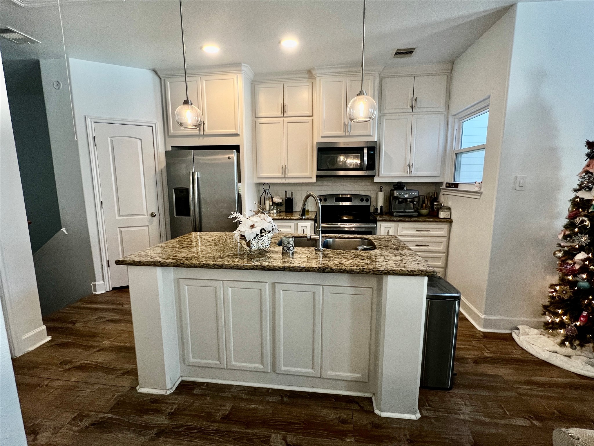 312 Mission Lane Houston, TX 77011 - Photo 3 of 19 a kitchen with stainless steel appliances granite countertop a sink refrigerator and cabinets