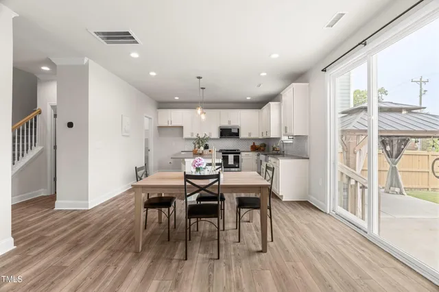 a kitchen with kitchen island white cabinets and white appliances