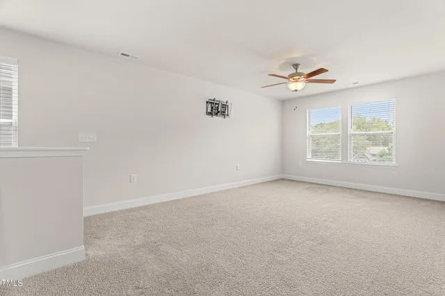 a spacious bedroom with a bed and a window