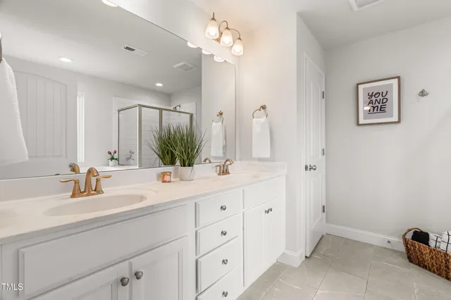 a bathroom with a tub shower and a sink