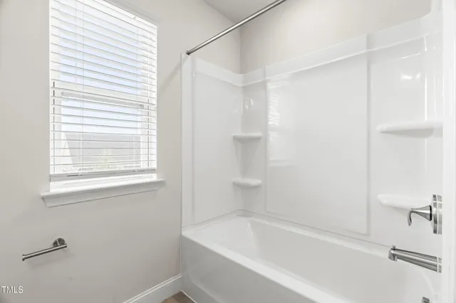 an empty room with a ceiling fan and a window