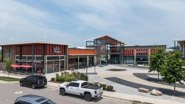 an aerial view of a house with yard swimming pool and outdoor seating