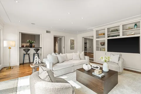 a bathroom with a double vanity sink a toilet and a tub