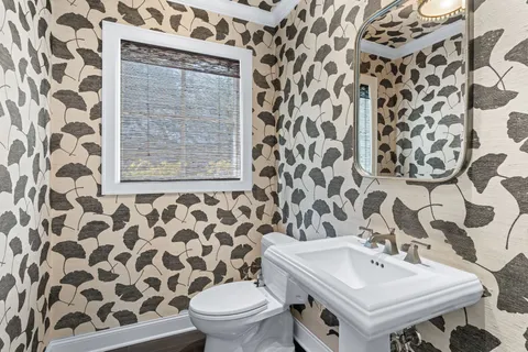 a kitchen with white cabinets and a window
