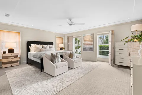 a bedroom with a large bed and a large window