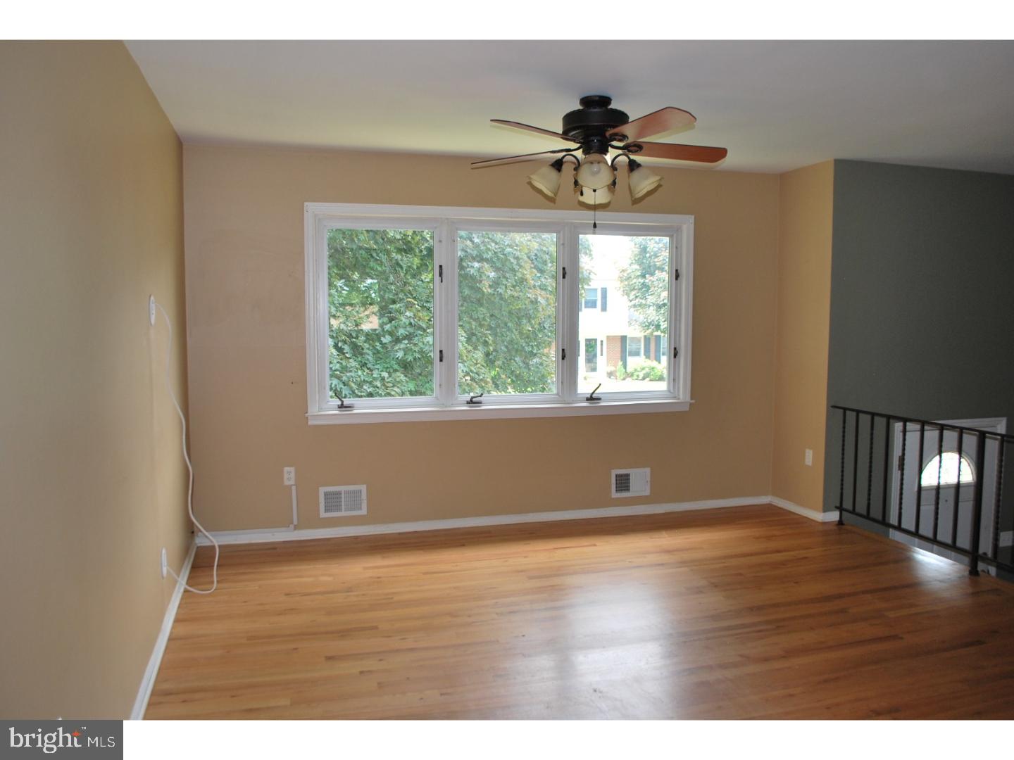 58 Elmont Road Trenton, NJ 08610 - Photo 5 of 20 a view of an empty room with wooden floor and a window