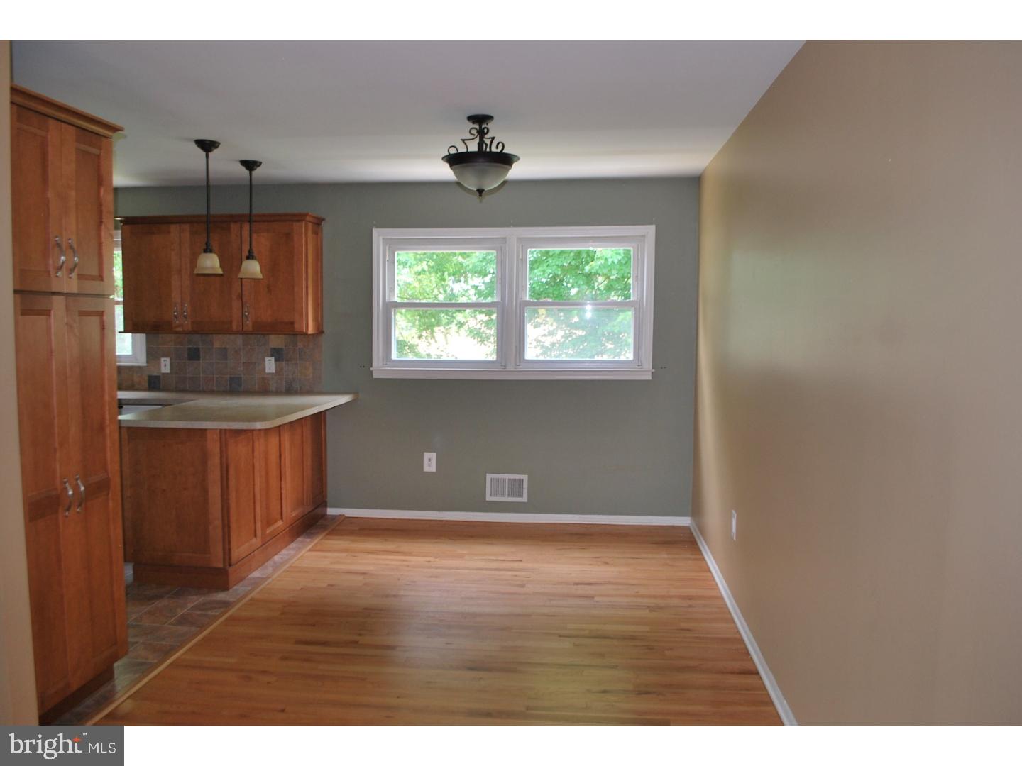 58 Elmont Road Trenton, NJ 08610 - Photo 9 of 20 a kitchen with kitchen island granite countertop a sink window and refrigerator