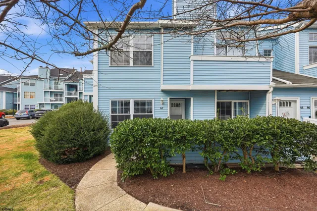 a view of a house with brick walls and potted plants
