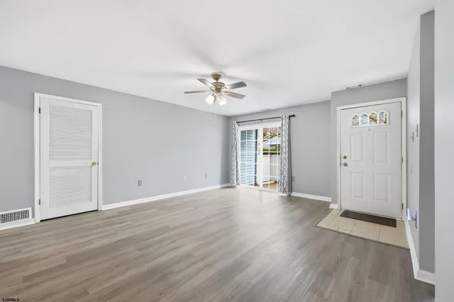 a view of a kitchen counter space a sink wooden floor and a window