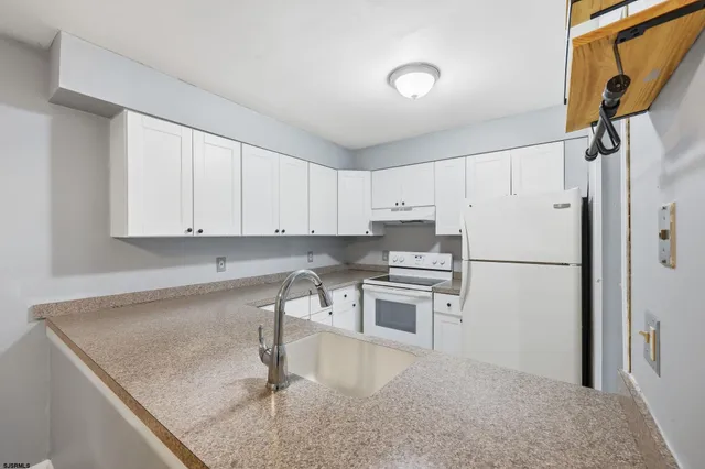 a bathroom with a granite countertop sink a large mirror and a window
