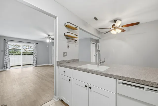 a kitchen with white cabinets and white appliances