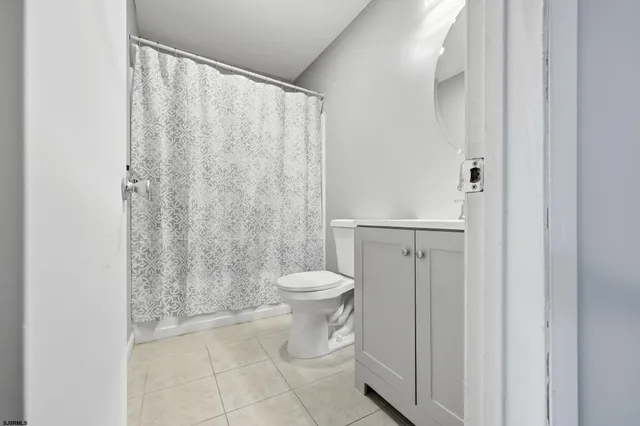 a bathroom with a toilet and a mirror