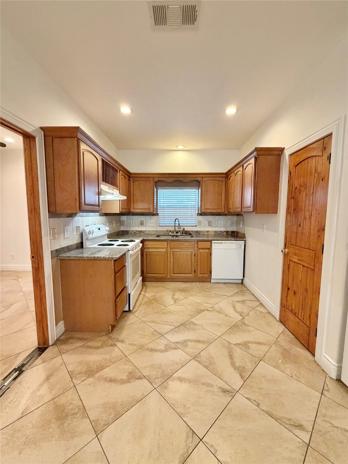 1530 Dearing Street Port Neches, TX 77651 - Photo 11 of 28 a large kitchen with stainless steel appliances granite countertop a stove a sink a microwave and a refrigerator
