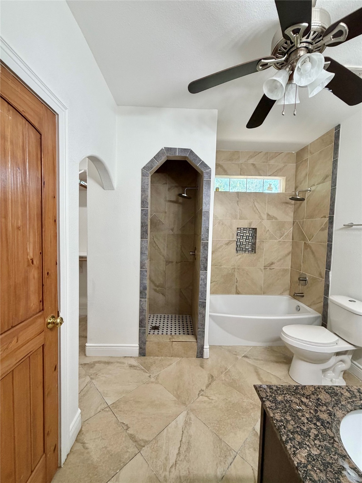 1530 Dearing Street Port Neches, TX 77651 - Photo 17 of 28 a bathroom with a granite countertop sink a toilet and shower