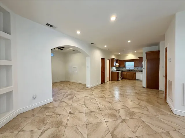 a view of empty room with a fireplace