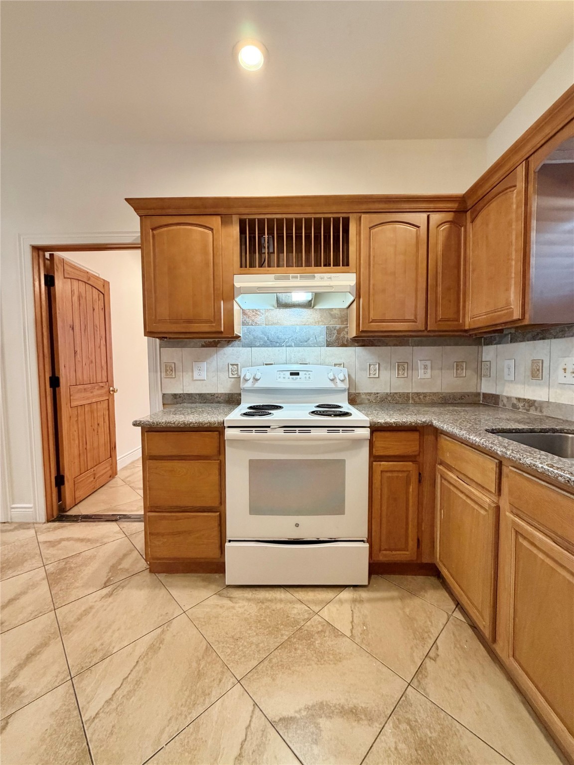 1530 Dearing Street Port Neches, TX 77651 - Photo 10 of 28 a kitchen with stainless steel appliances granite countertop a stove and a sink