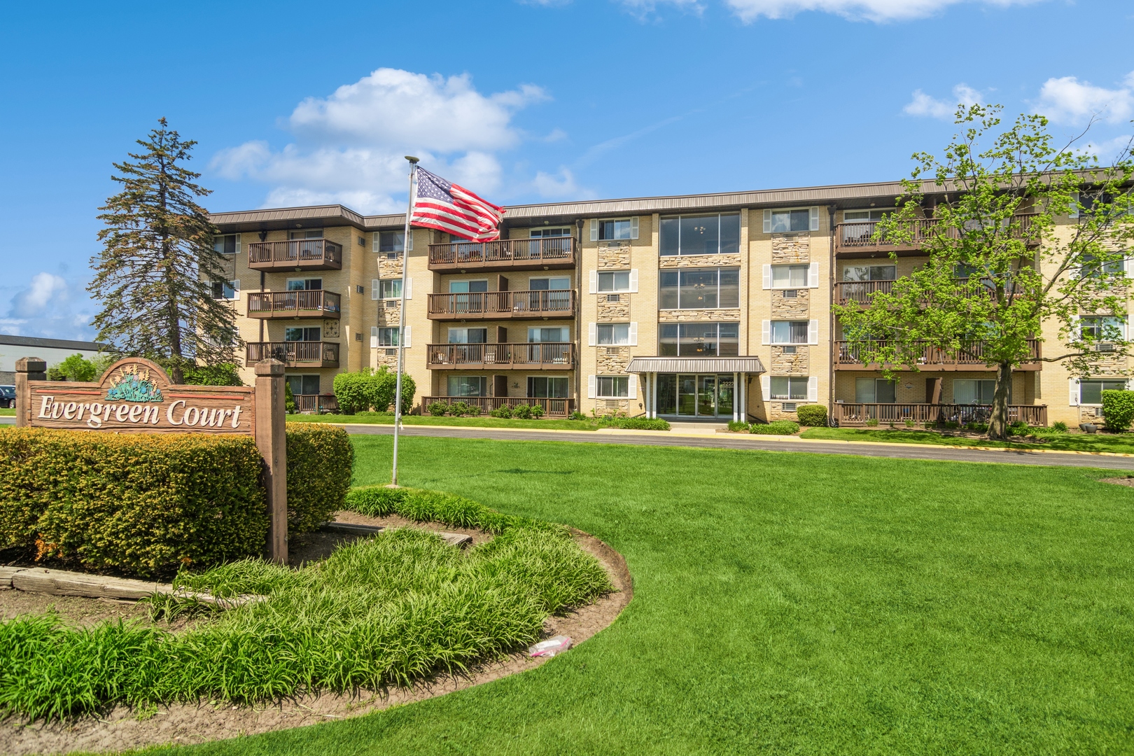 2222 South Goebbert Road, Unit 256 Arlington Heights, IL 60005 - Photo 1 of 15 a front view of a building with a garden
