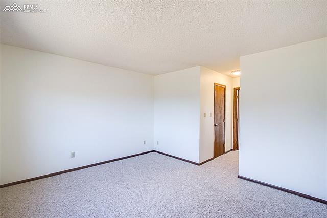 3780 Range View Road Monument, CO 80132 - Photo 15 of 33 Master bedroom with walk in closet and attached bath.