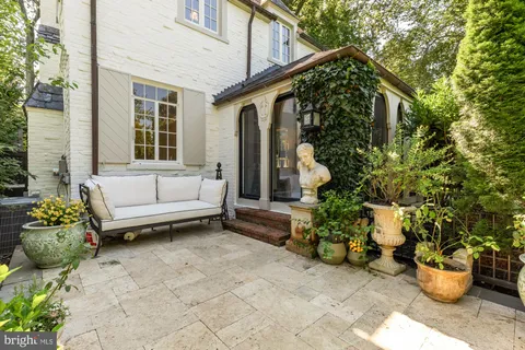 a view of a patio with couches and potted plants