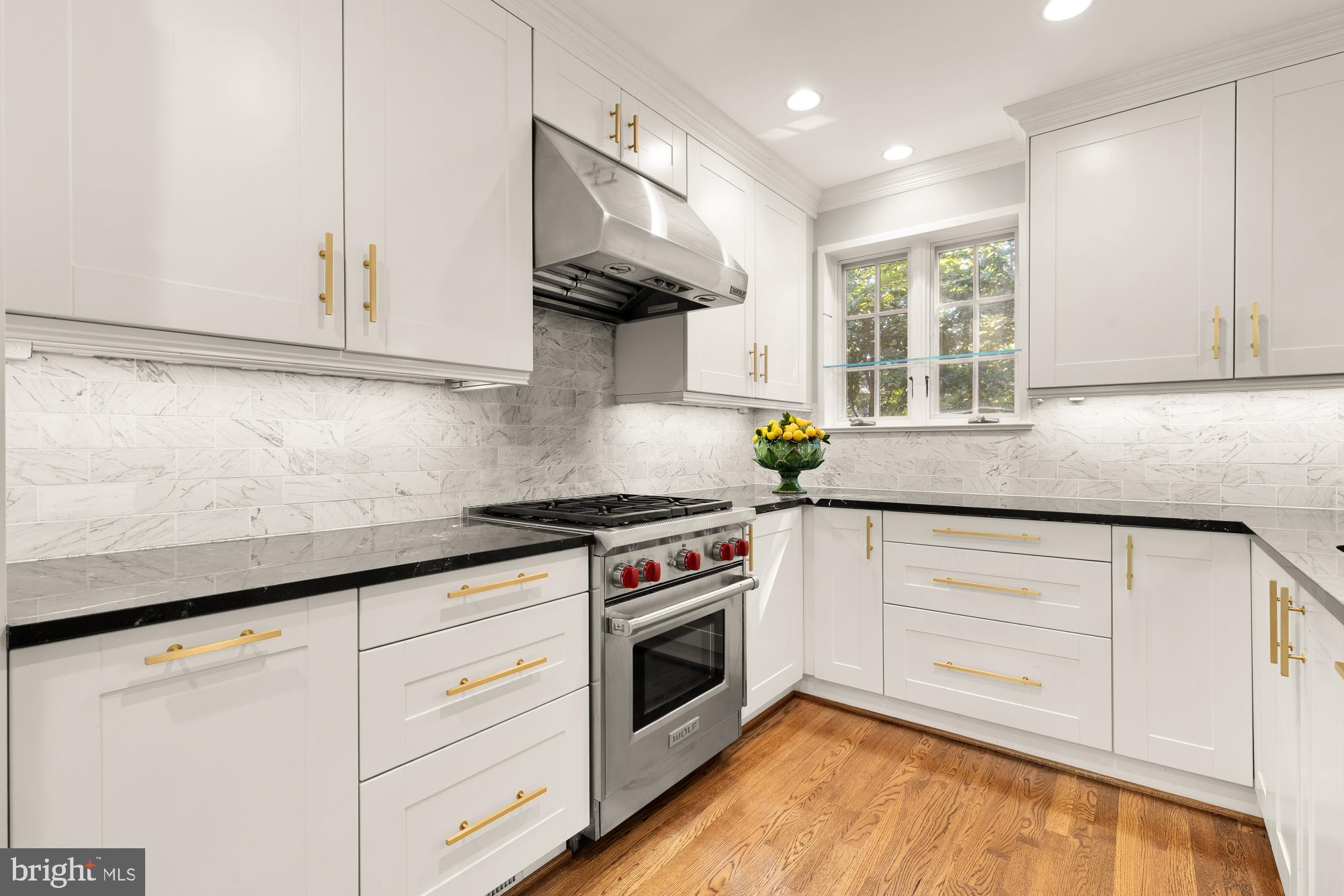 3110 Rolling Road Chevy Chase, MD 20815 - Photo 18 of 64 a kitchen with granite countertop white cabinets stainless steel appliances and a sink