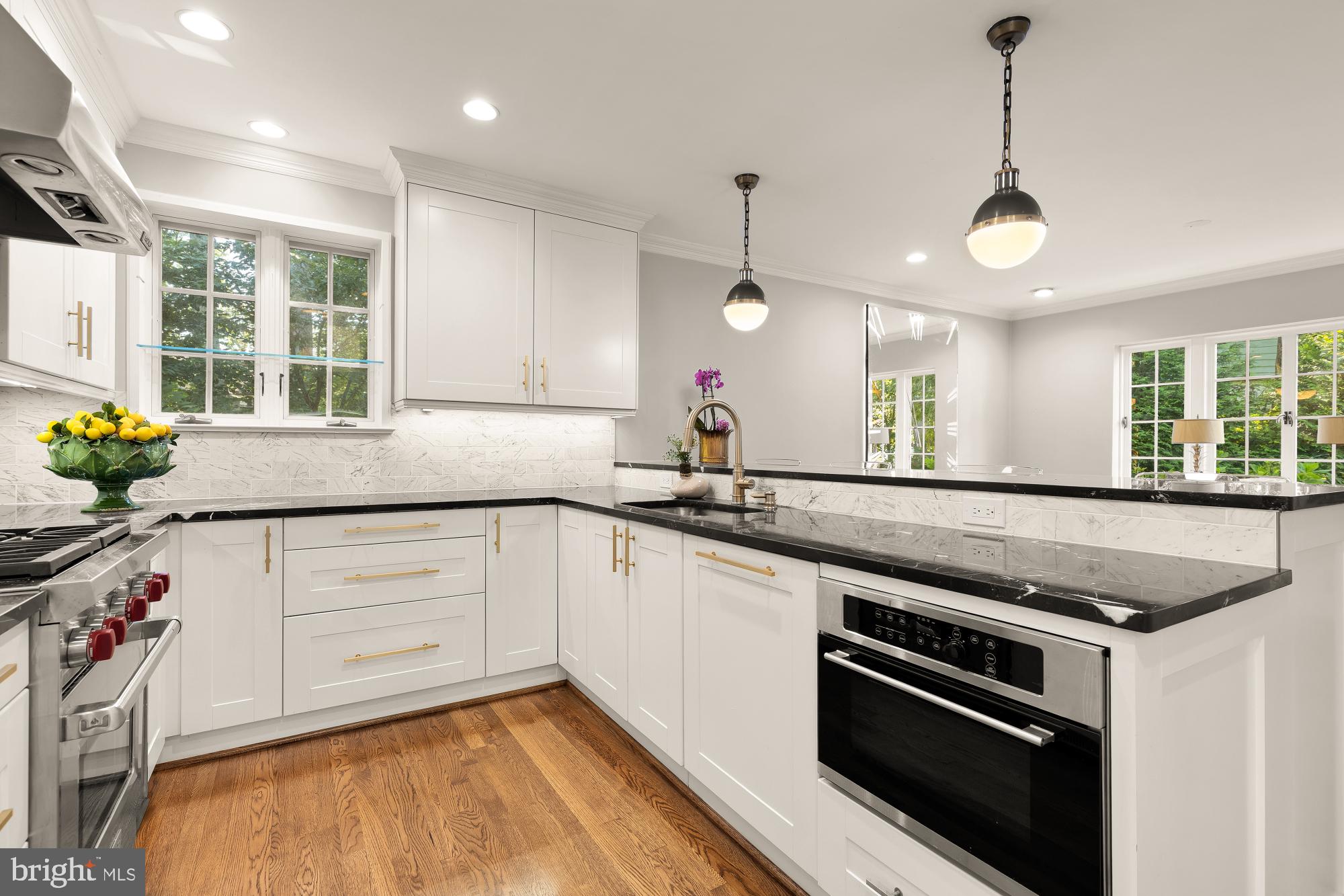 3110 Rolling Road Chevy Chase, MD 20815 - Photo 19 of 64 a kitchen with stainless steel appliances granite countertop a stove a sink and a granite counter tops with white cabinets