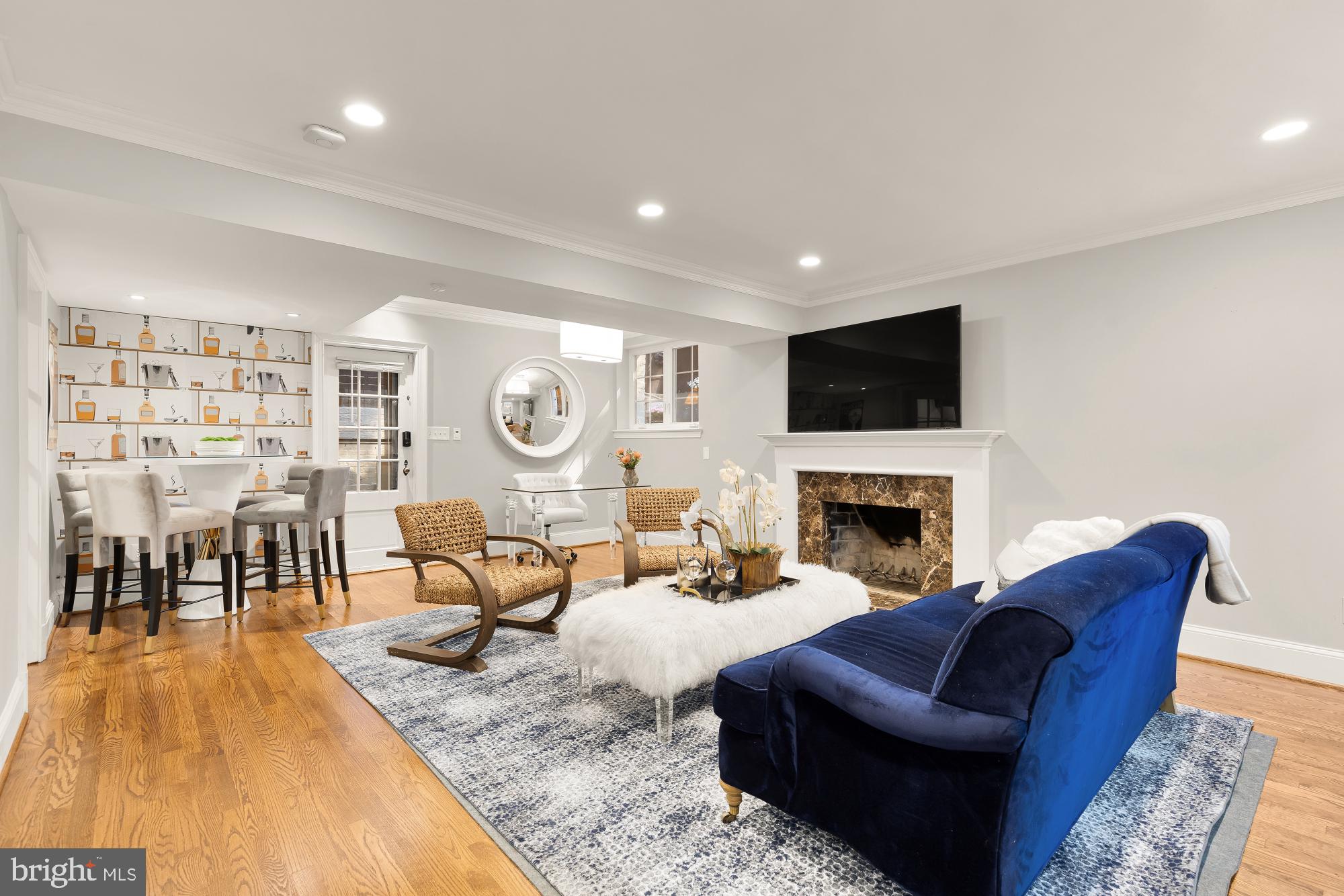 3110 Rolling Road Chevy Chase, MD 20815 - Photo 24 of 64 a living room with furniture a fireplace and a flat screen tv