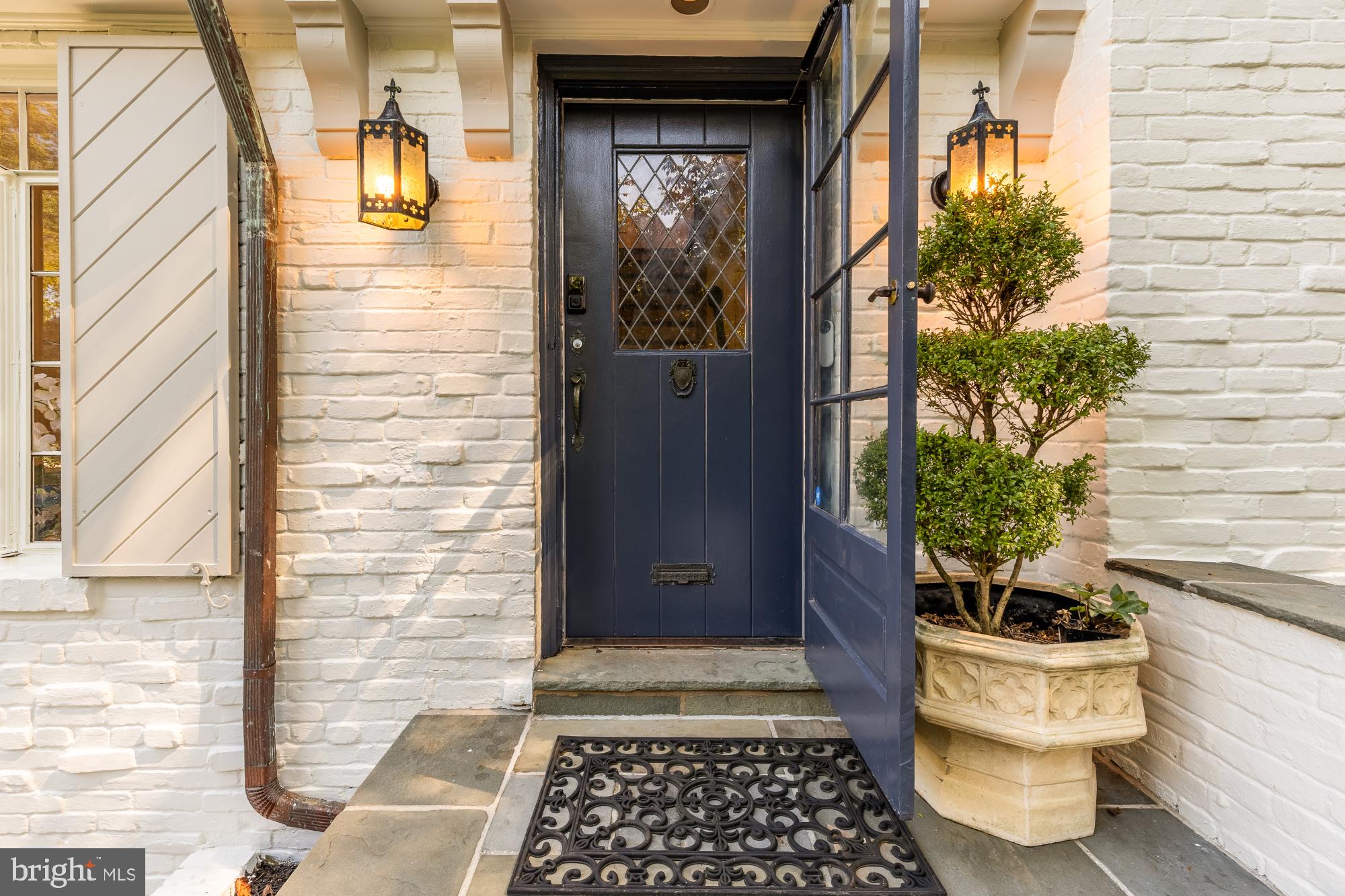 3110 Rolling Road Chevy Chase, MD 20815 - Photo 3 of 64 a view of a door and chair and potted plant