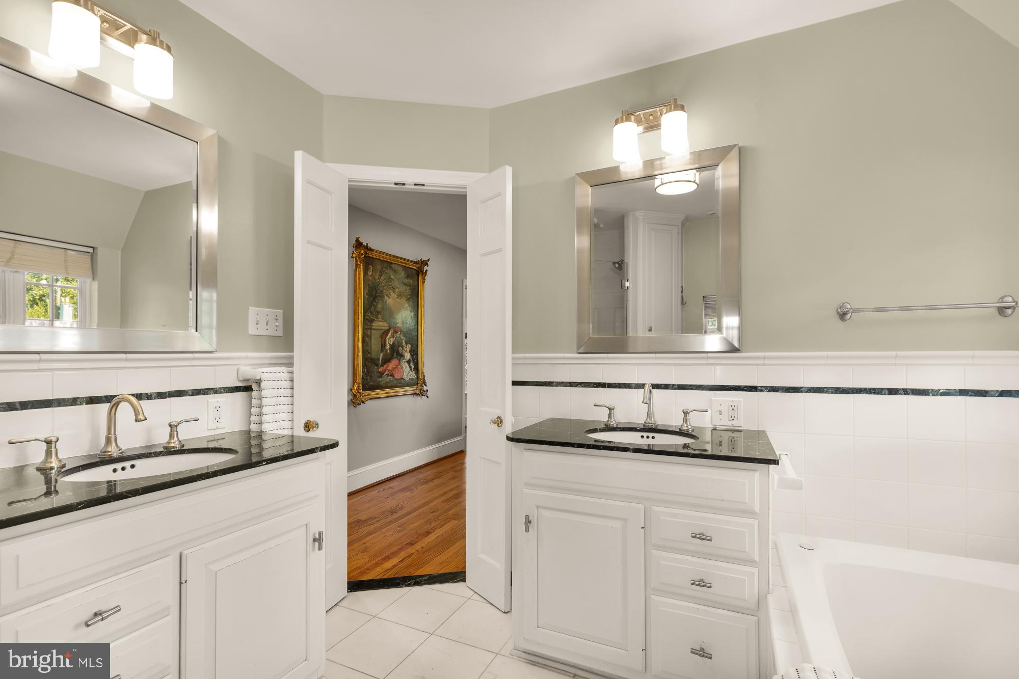 3110 Rolling Road Chevy Chase, MD 20815 - Photo 33 of 64 a bathroom with a sink and a mirror