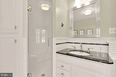 a bathroom with a sink a toilet and a mirror