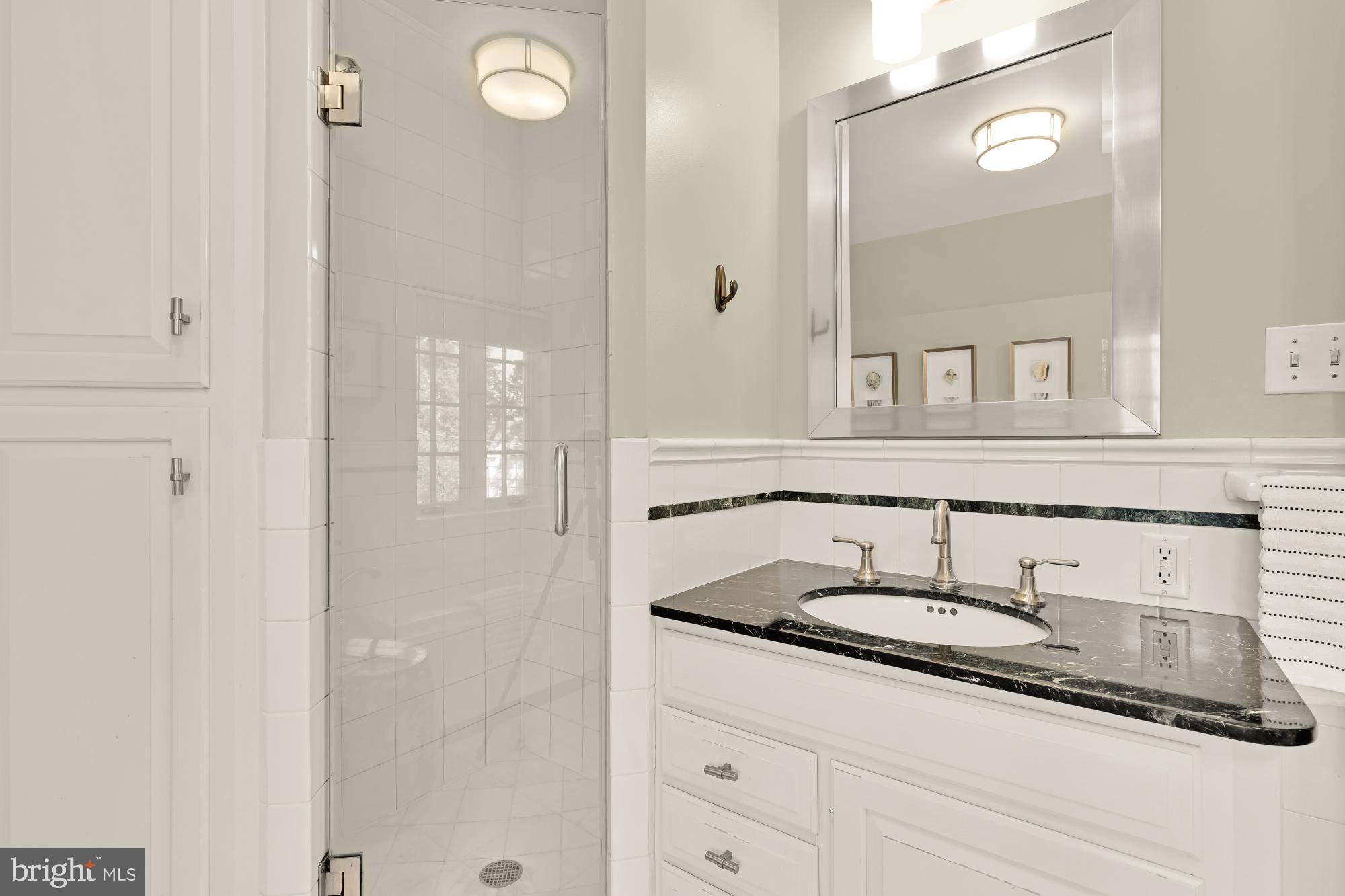 3110 Rolling Road Chevy Chase, MD 20815 - Photo 34 of 64 a bathroom with a sink and a mirror