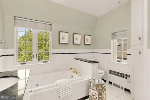 a living room with a bed furniture and a potted plant