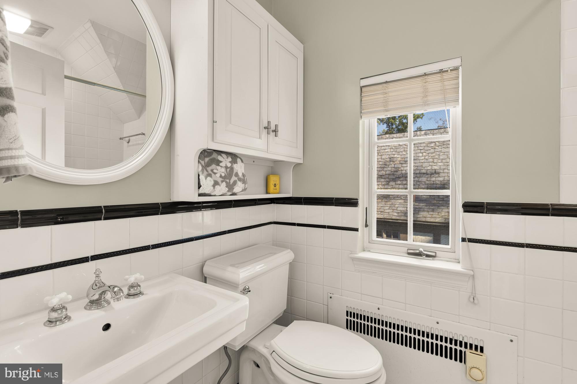 3110 Rolling Road Chevy Chase, MD 20815 - Photo 39 of 64 a bathroom with a sink a toilet and a mirror