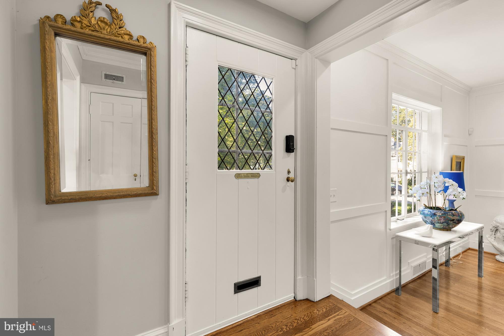 3110 Rolling Road Chevy Chase, MD 20815 - Photo 4 of 64 a view of a hallway that has a dresser and a window in it
