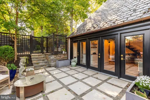 a view of a backyard with swimming pool and sitting area