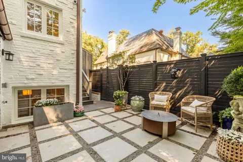a view of a porch with furniture and trees
