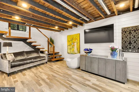 a front view of a house with a yard and potted plants