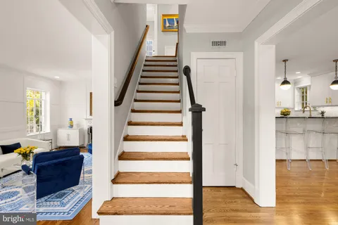 a view of entryway and hall with wooden floor