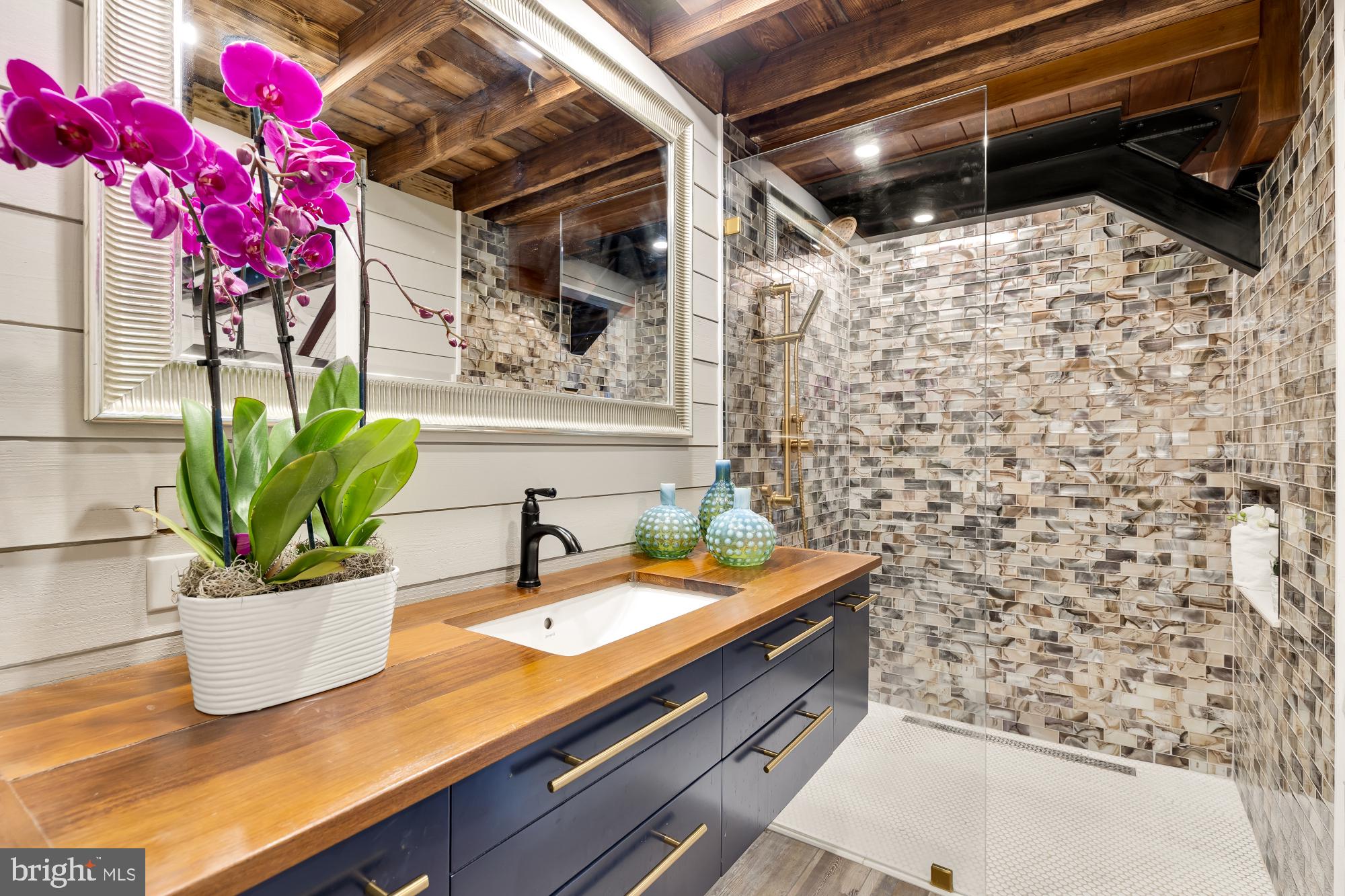 3110 Rolling Road Chevy Chase, MD 20815 - Photo 51 of 64 a bathroom with a granite countertop sink a mirror and shower