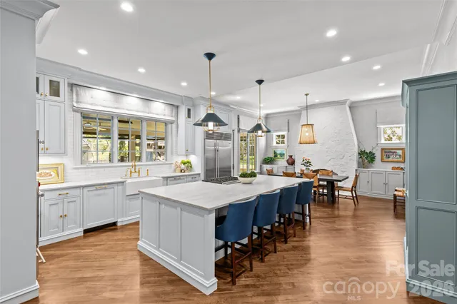 a large kitchen with lots of counter space and stainless steel appliances